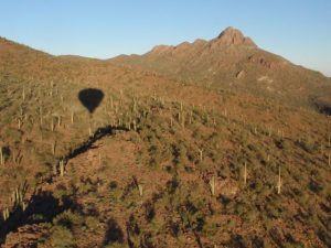 Our shadow preceded us as we flew toward Sombrero Peak.