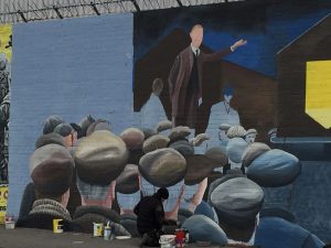 An artist works on a new mural. 